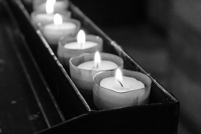 Close-up of candles on votive stand in church