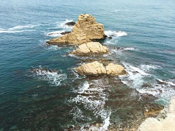 High angle view of rock in sea