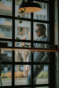 Man looking through window