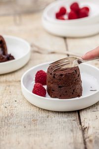 Close-up of hand holding ice cream in plate