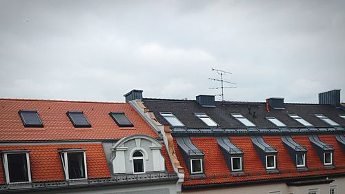 Low angle view of buildings against cloudy sky