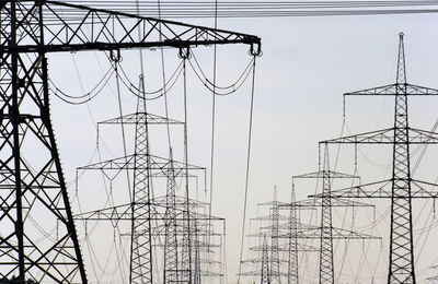 Low angle view of electricity pylon against sky