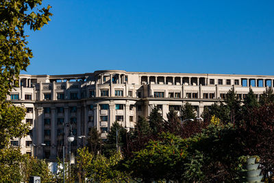 Low angle view of building against clear blue sky