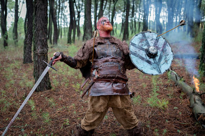 Full length of man standing in forest