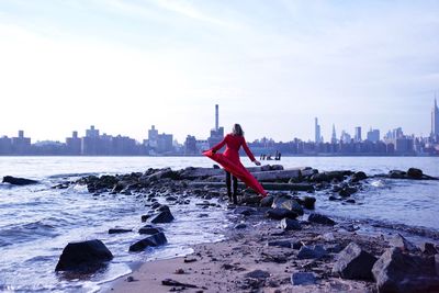 View of sea and cityscape against sky