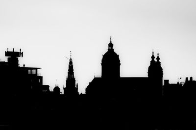 Silhouette of buildings against clear sky