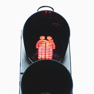 Low angle view of road sign against white background