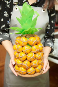 Midsection of woman holding strawberries