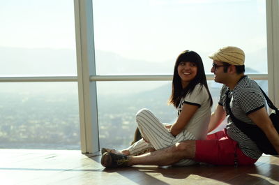 Couple bonding, sitting on floor, sky costanera, costanera center, chile