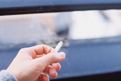 Cropped hand of person with cigarette