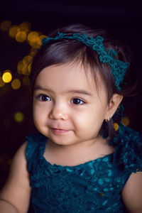 Girl in blue dress in studio with gold sequins and garland