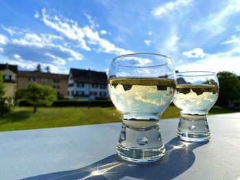 Close-up of drink on table against sky