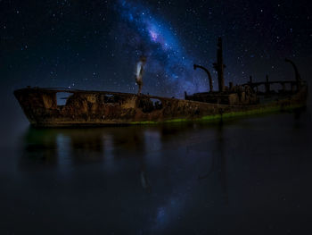 Scenic view of lake against sky at night