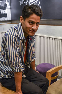 Portrait of young man sitting outdoors