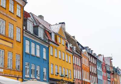 Low angle view of multi colored houses against sky