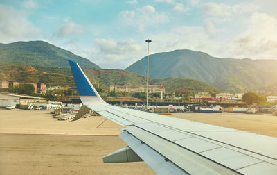 Airplane wing against sky