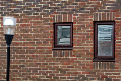 Low angle view of window on brick wall