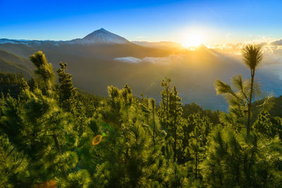 Scenic view of mountains against sky at sunset