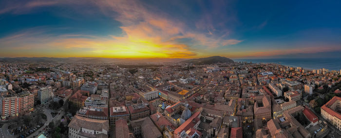 Aerial view of townscape against sky during sunset