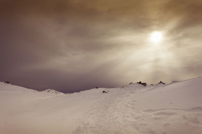 Scenic view of snow covered mountain against sky