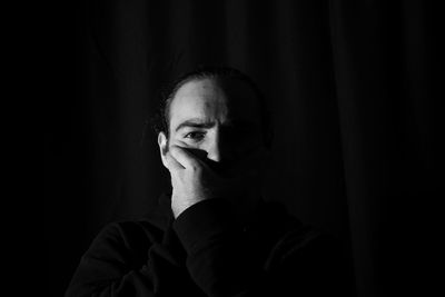 Portrait of young man in darkroom