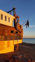 Construction site by sea against clear sky