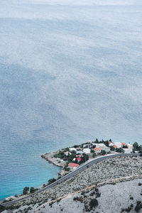 High angle view of rocks by sea against sky