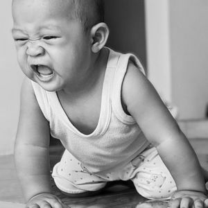 Midsection of boy sitting at home