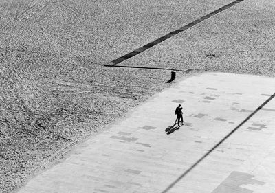 High angle view of people walking on walkway during sunny day