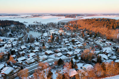 Aerial view of snow covered landscape during sunset