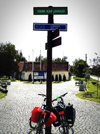 Road sign against sky