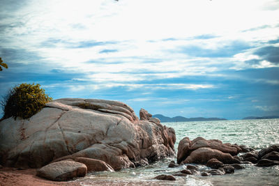 Rocks on beach against sky