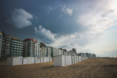 Low angle view of buildings on field against sky