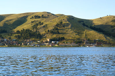 Scenic view of sea by buildings against sky