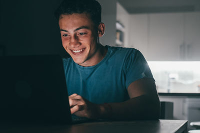 Young man using laptop at home