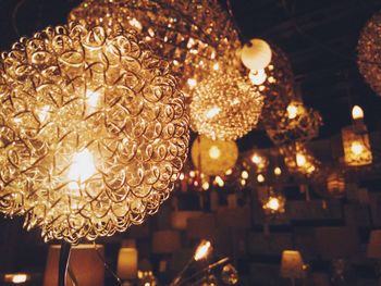 Low angle view of illuminated light bulbs