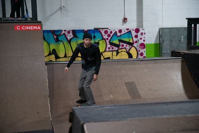 Full length of young man skateboarding on wall