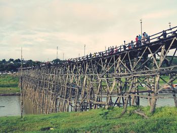 Bridge over field against sky