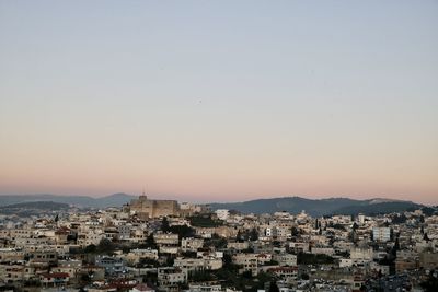 Aerial view of townscape against sky at sunset