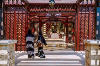 People walking in temple outside building