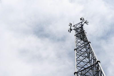 Low angle view of communications tower against sky