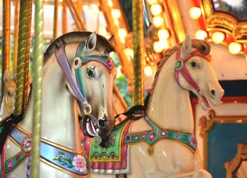 Close-up of carousel horses in amusement park