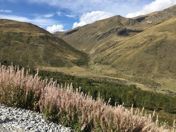 Scenic view of land and mountains against sky