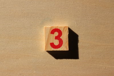 Close-up of number 3 on wood