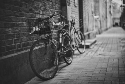 Bicycle parked on sidewalk by building