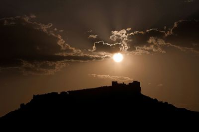 Low angle view of silhouette building against sky during sunset