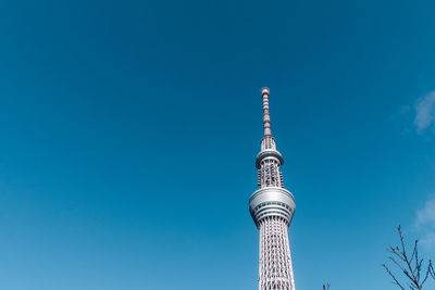 Low angle view of tower against blue sky