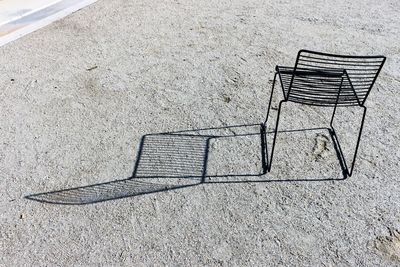 High angle view of empty bench on field