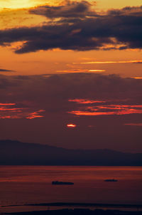 Scenic view of sea against romantic sky at sunset