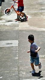 High angle view of boy walking on road